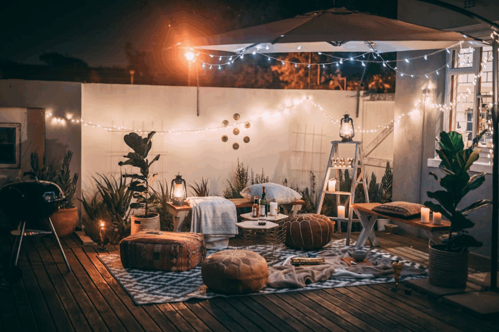 Cozy outdoor patio setup with candles, lanterns, and string lights creating a safe and stylish evening atmosphere.