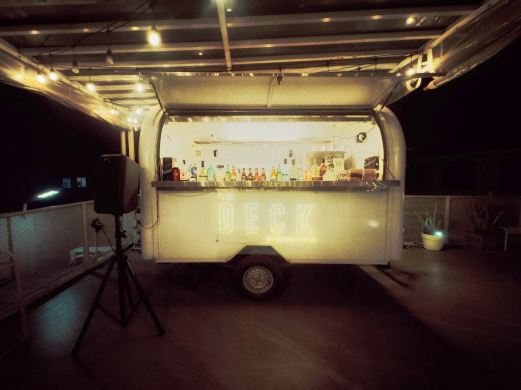 A mobile bar setup with string lights at night